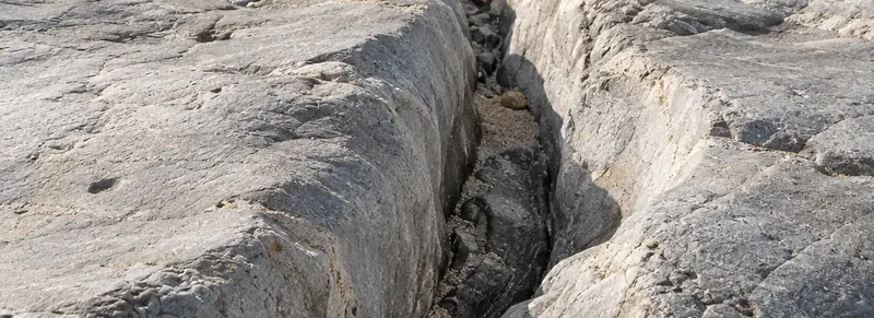 A defined joint between coastal rock formations.